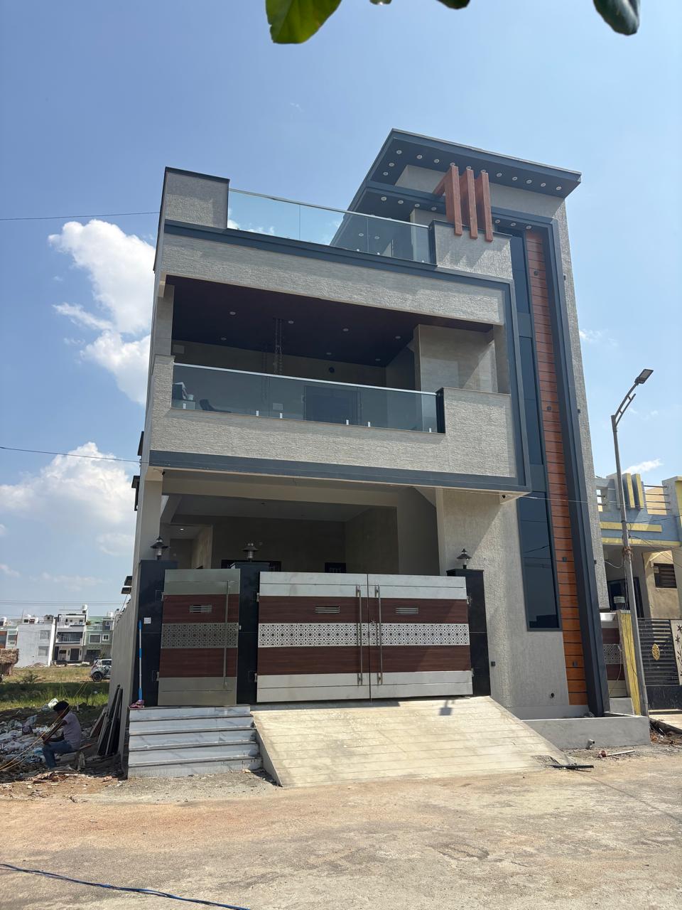 Modern G+2 residence with glass balcony railing